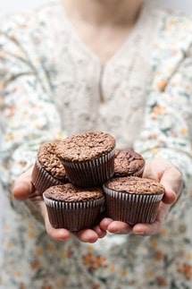 Woman extending a hand to offer food