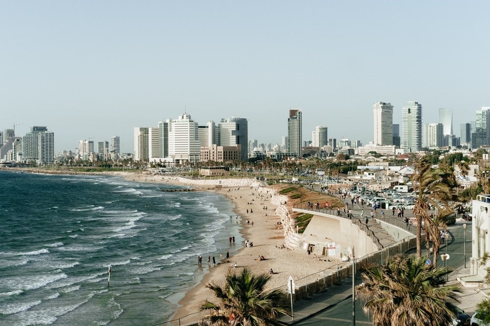 A beach in Tel Aviv with buildings visible in the background