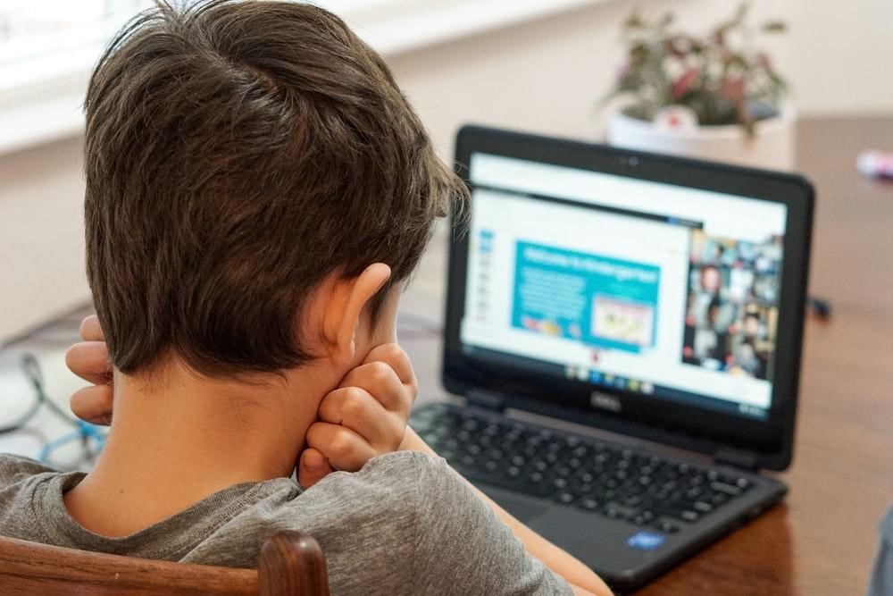 child learning from a laptop