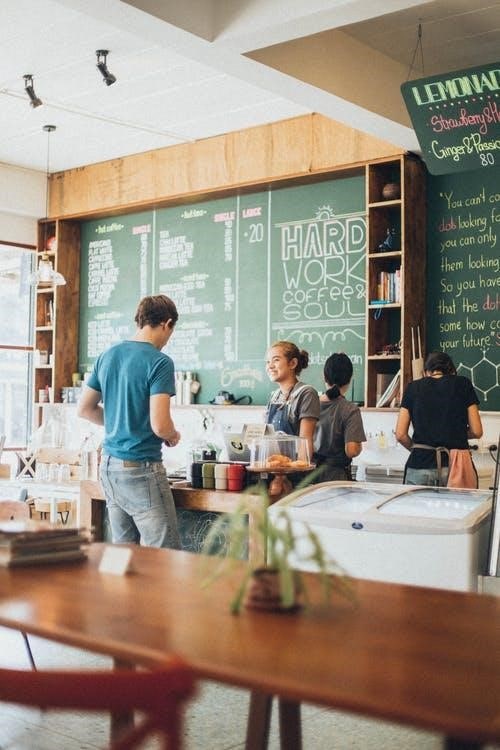 Person speaking to a worker in a café